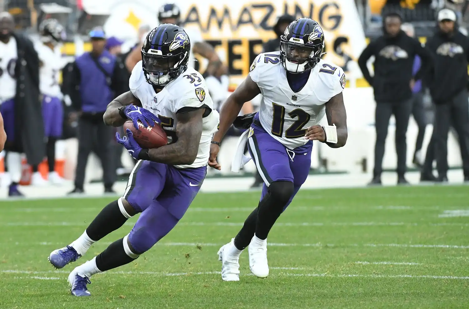 Baltimore Ravens running back Gus Edwards (35) after taking a handoff from quarterback Anthony Brown (12) while playing the Pittsburgh Steelers during the fourth quarter at Acrisure Stadium. The Steelers lost 16-14. Mandatory Credit: Philip G. Pavely-USA TODAY Sports