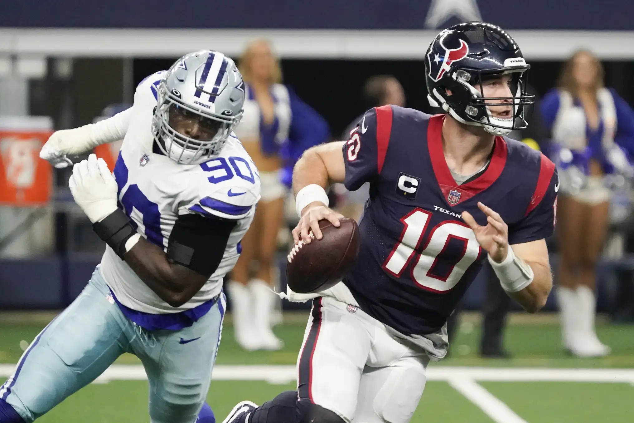 Houston Texans quarterback Davis Mills (10) scrambles from the pressure by Dallas Cowboys defensive end DeMarcus Lawrence (90) during the second half at AT&T Stadium. Mandatory Credit: Raymond Carlin III-USA TODAY Sports