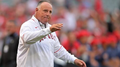
Jun 22, 2022; Anaheim, California, USA; Los Angeles Angels former manager Mike Scioscia waves to the crowd as he is introduced during a pregame ceremony honoring the 20th anniversary World Series title in 2002 at Angel Stadium. Jayne Kamin-Oncea-USA TODAY Sports
