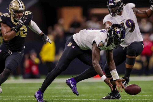 
Nov 7, 2022; New Orleans, Louisiana, USA; Baltimore Ravens quarterback Lamar Jackson (8) fumbles the football but recovers it against the New Orleans Saints during the first half at Caesars Superdome. Mandatory Credit: Stephen Lew-USA TODAY Sports


