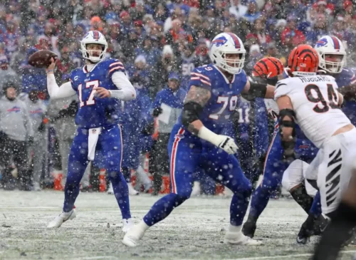 
Bills quarterback Josh Allen looks for an open receiver while teammate Spencer Brown looks to block Bengals Sam Hubbard during first half action in their playoff game at Orchard Park on Jan. 22.
